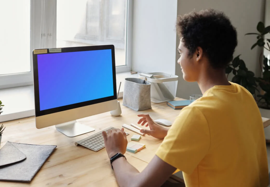 Young boy smiling at an iMac mockup